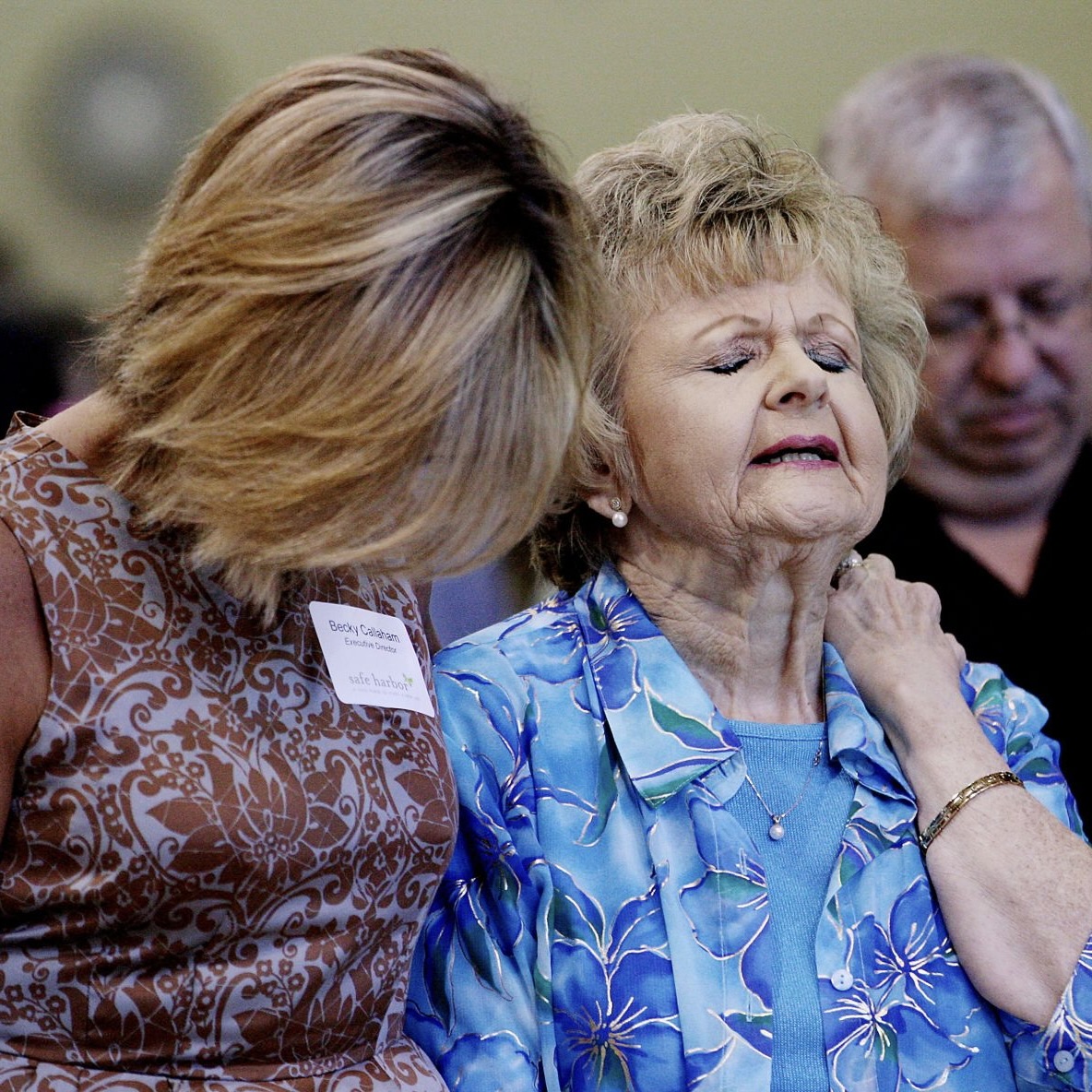 Jenna Henson Black (right) is overcome with emotion and is comforted by Safe Harbor Executive Director Becky Callaham during the opening of the new Oconee County women’s shelter. Black has been raising money for the shelter since 2004 after she fled her abusive husband of 18 years. Grace Beahm/Staff ¬